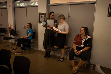 Inside the Wadeye police station and courthouse, North Australian Aboriginal Justice Agency (NAJA) lawyers, Holly Fitzsimmons and Kate Ballard, discuss upcoming cases at the back of the room.  Norther...