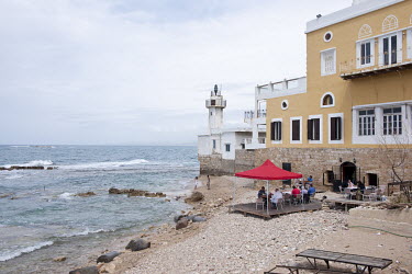 A lighthouse and the Al Fanar Restaurant on the Mediterranean coast.