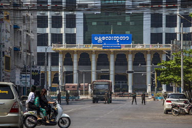 Soldiers holding metal sticks stand in guard as they block the area in front of the Mandalay central railway station where tens of thousands of protestors gathered the previous week.
