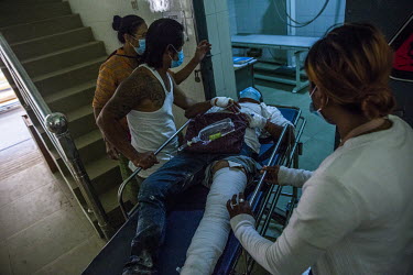 Anti-coup protestor Ko Than Tun Aung is brought to clinic treating injured protestors after he was shot in the leg with a live round as military and police cracked down on a protest using gunfire, rub...