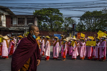 Buddhist nuns, carrying placards calling for US military action, march to protest against the military coup.