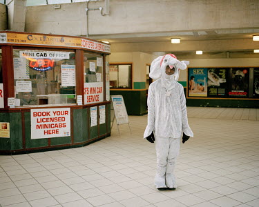 Dressed as a white elephant, Efemena Agadama collects money for charity in Cockfosters Station.
