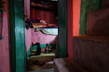 A boy plays on the floor in a small, one room home, in the urban refugee camp popularly known as 'Geneva Camp'. The people living in the area are related to Muslims who moved here mostly, but not excl...