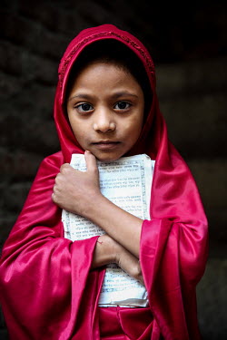 A girl wearing red in the urban refugee camp popularly known as 'Geneva Camp'. The people living in the area are related to Muslims who moved here mostly, but not exclusively, from Bihar in India afte...