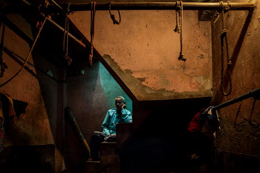 A man sits on a flight of steps in the urban refugee camp popularly known as 'Geneva Camp'. The people living in the area are related to Muslims who moved here mostly, but not exclusively, from Bihar...