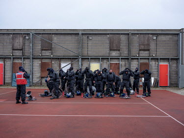 Police officers don their riot gear during public order training at the Metropolitan Police's training centre in Gravesend.
