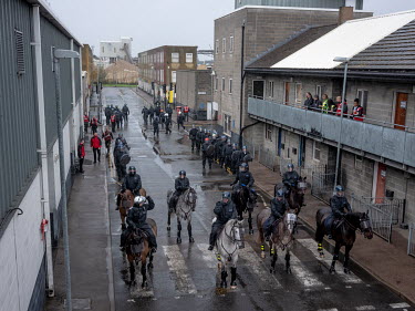 Mounted police move through a purpose built street to disperse 'protesters' during an exercise at the police training centre in Gravesend.