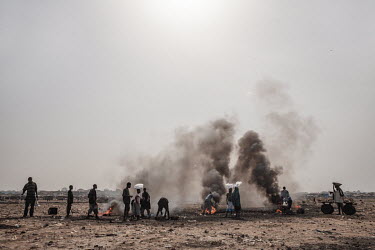 Men and children burn cables from computers and other electronic equipment to retrieve copper, at Agbogbloshie dump, which has become a dumping ground for computers and electronic waste from all over...