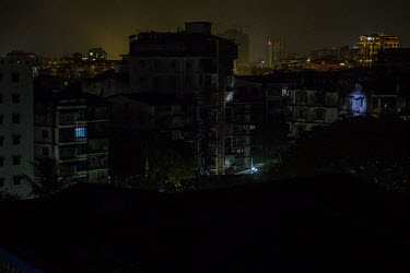 After the start of the nightly curfew, imposed by the military, residents across the city turn off lights while military and police joint security forces move around lighting up buildings with torch l...