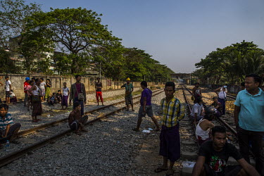 Civilians gather near the compound of the railway staff quarters where security forces are deployed to carry out a raid aimed at staff who are participating in the Civil Disobedience Movements.