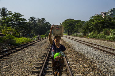 A woman carries her belongings as she leaves the railway staff quarters where security forces have been deployed to carry out a raid aimed at staff who are participating in the Civil Disobedience Move...