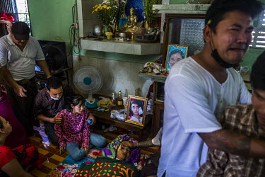 Aye Myat Thu, the sister of Ko Chit Min Thu (25) is comforted by relatives as she mourns the death of her brother. He was shot in the head with live ammunition fired by security forces while trying to...