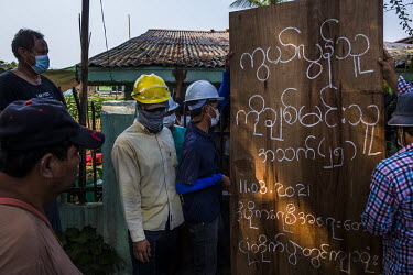 People post a notice-board at the funeral home following the death of Ko Chit Min Thu (25) who was shot in the head with live ammunition fired by security forces while trying to protect protestors fro...