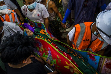 Worried that the security forces will come to claim Ko Chit Min Thu's dead body, volunteer medics move his body. Ko Chit Min Thu (25) was shot in the head with live ammunition fired by security forces...