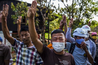 Friends and neighbours raise their hands to give give the three fingers pro-democracy salute as they mourn the death of Ko Chit Min Thu (25) who was shot in the head with live ammunition fired by secu...