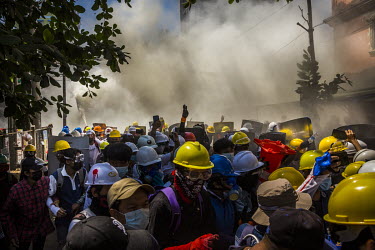 Youth protestors let off fire-extinguishers to obscure the vision of police and military joint security forces who are firing tear-gas, sound grenades and rubber bullets at them as they crack down on...