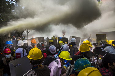 Youth protestors let off fire-extinguishers to obscure the vision of police and military joint security forces who are firing tear-gas, sound grenades and rubber bullets at them as they crack down on...