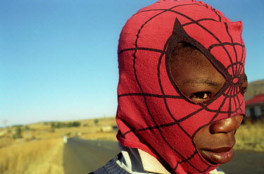 A young boy with a spiderman mask.