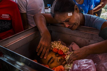 The mother of Aung Zin Myint, mourns beside his dead body. The 20 year old student was shot in the chest and arm by the security forces who fired on anti-coup protestors earlier in the morning in the...