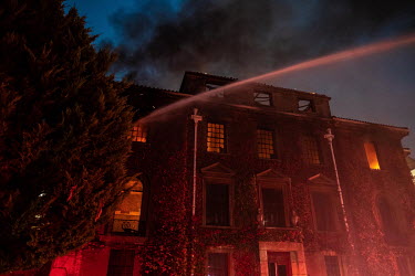 Firemen use high pressure hoses to battle a blaze in the University of Cape Town's Jagger Library, home to a huge collection of rare and valuable books and papers. The fire began on Table Mountain but...