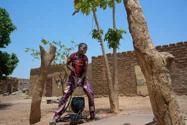 Roger (13) collecting water from the well at his home. Roger has been an apprentice bicycle repairer since October 2020. Following the COVID-19 economic crisis, and the closing of the borders, his fat...