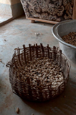 Bedine (10), a housekeeper for a local family, shells peanuts. Its not unusual for the families of young girls to send them to work to wealthier families, to help with household chores.