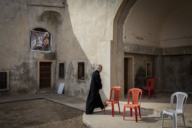 Father Banham Lalo in the grounds of the new Mar Goris Syriac-Catholic church (St George) which has been partially rebuilt following its destruction by Islamic State during their occupation of the tow...