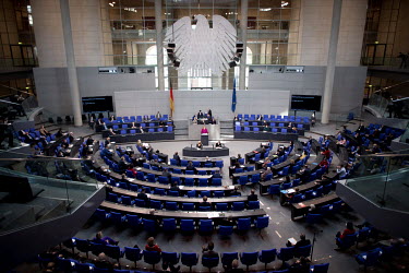 Chancellor Angela Merkel, of the CDU, adresses legislators during a socially distanced session of the German parliament (Deutscher Bundestag) where MPs debated coronavirus restrictions.