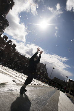 Children playing with soap bubbles on the closed Oberbaum Bridge during a protest calling for a 'Global Day of Climate Action' under the slogan 'Another World Is Possible'.