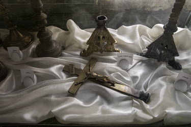 A metal crucifix and various candlestick holders, some of the relics on display at the new Mar Goris Syrias-Catholic church (St George) which was burned and badly damaged by ISIS terrorists when they...