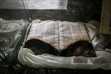 A partially burnt Aramaic Bible, one of the relics on display at the new Mar Goris Syriac-Catholic church (St George). The church was desecrated and badly burnt by ISIS terrorists when they took contr...