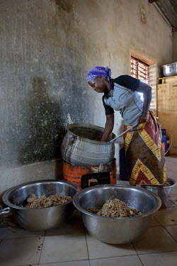 A cook prepares food for the school canteen at the Denro associative school is a major element in encouraging parents and pupils to continue their studies. For many families, poor or internally displa...