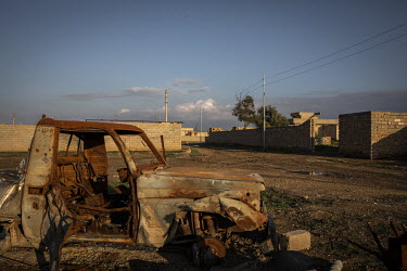 The rusting remains of a vehicle sits in the now abandoned Yazidi village of Kocho which still lies in ruins more than four years after it was liberated from ISIS rule.