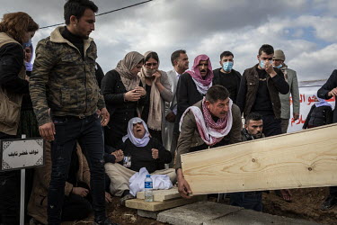 A Yazidi family bury the remains of a young male relative, one of 103 people from the village murdered by ISIS in 2014. Having been exhumed from the mass graves where they were dumped by ISIS, the vic...