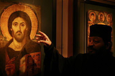 A monk pointing to one of the oldest Byzantine icons kept in the St Catherine's monastery museum.   The Greek Orthodox monastery is among the oldest Christian monasteries, and the smallest dioceses,...