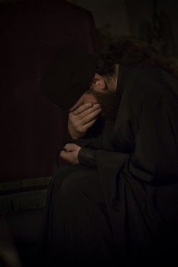 An Orthodox monk praying during morning mass in Crna Reka Monastery.