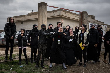 A group of distraught female relatives weep and cry out as the funerary procession for 103 Yazidi victims of ISIS passes them by. Having been exhumed from the mass graves where they were dumped, after...