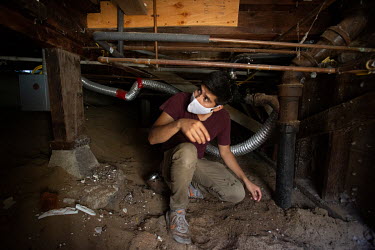 Eli Cortes fixes a bathroom with his father, Jose, at a house in Marina del Rey. Eli lost his job at a restaurant when the coronavirus pandemic started and his father needed his help on a project. Eli...