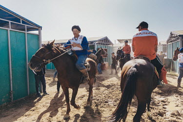 A Russian Kok-Boru player collects his horse from the stables ahead of his team's 3rd place play-off match with Kazakhstan at the World Nomad Games.