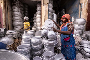 Women working in a stall selling recycled aluminium cooking pots in Kejetia market (Kumasi Central Market).