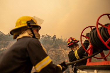 Fire fighters battle a wildfire on Table Mountain, attempting to stop it from reaching residential areas in Cape Town.