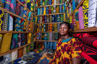 Fabric seller Rita Owusu (35) in her stall in Kejetia market (Kumasi Central Market) where she sells both locally manufactured and imported printed wax fabrics (Dutch wax prints) which remain extremel...