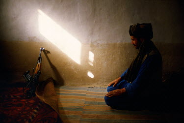 A mujahideen fighter offers prayers.