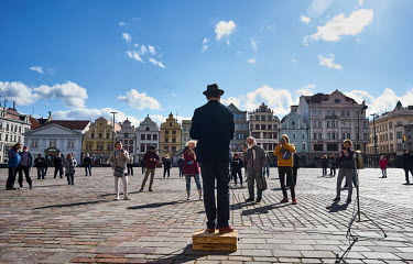 People watach and film a street entertaininer in the historic central city centre.