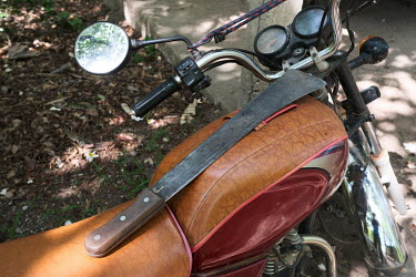 A machete on a traditional healer's motorcycle in the Tobe protected forest. Some 350 hectares in area, the forest had been severely degraded by agriculture. Over the last 35 years it has been restore...
