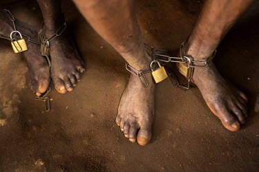 Chains shackling the ankles of patients being treated for mental health issues at Oke Oloro where the use of chains to restrain people is common practice. Traditional healer Sheu Saliu Ibrahim, who ru...