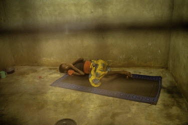 A patient lies on a mat in a bare room at the Jesus Divine Temple. Staff there say they stopped using chains to restrain people with mental health conditions two years ago. Some patients are now allow...