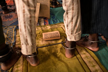 A man whose ankles are shackled with an iron bar at the Mamman Mai Mari Qur'anic Islamic and Rehabilitation Centre where men and boys, some as young as 10 years old, are shackled for perceived or actu...