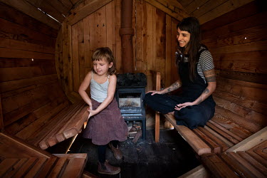 Charlie Tide and her daughter Tsari inside a sauna built by Charlie. The single mother has struggled with finding a home in the Byron Bay area having had to move over 20 times. Charlie has started a p...