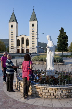 Pilgrims praying at Saint James' Church in Medugorje. The town has been a popular destination for pilgrimages since 1981 when it was reported that apparitions of the Virgin Mary appeared to six local...